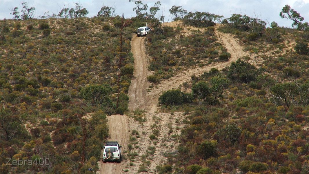 21-DJ watches how Zebra drive the dune next to the rusty border fence.JPG